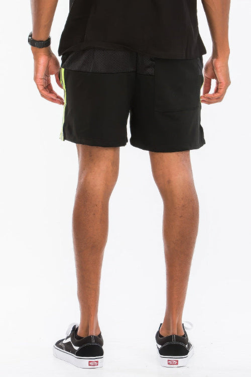 Person wearing black shorts on a white background