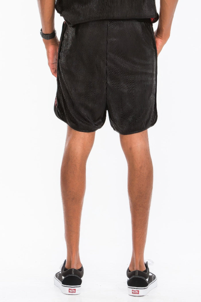 Person wearing black shorts on a white background