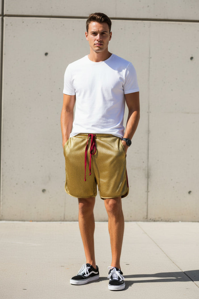 Person wearing mustard yellow shorts with a red drawstring on a white background