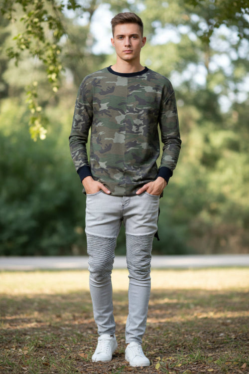 Camouflage long-sleeve shirt worn by a person on a white background