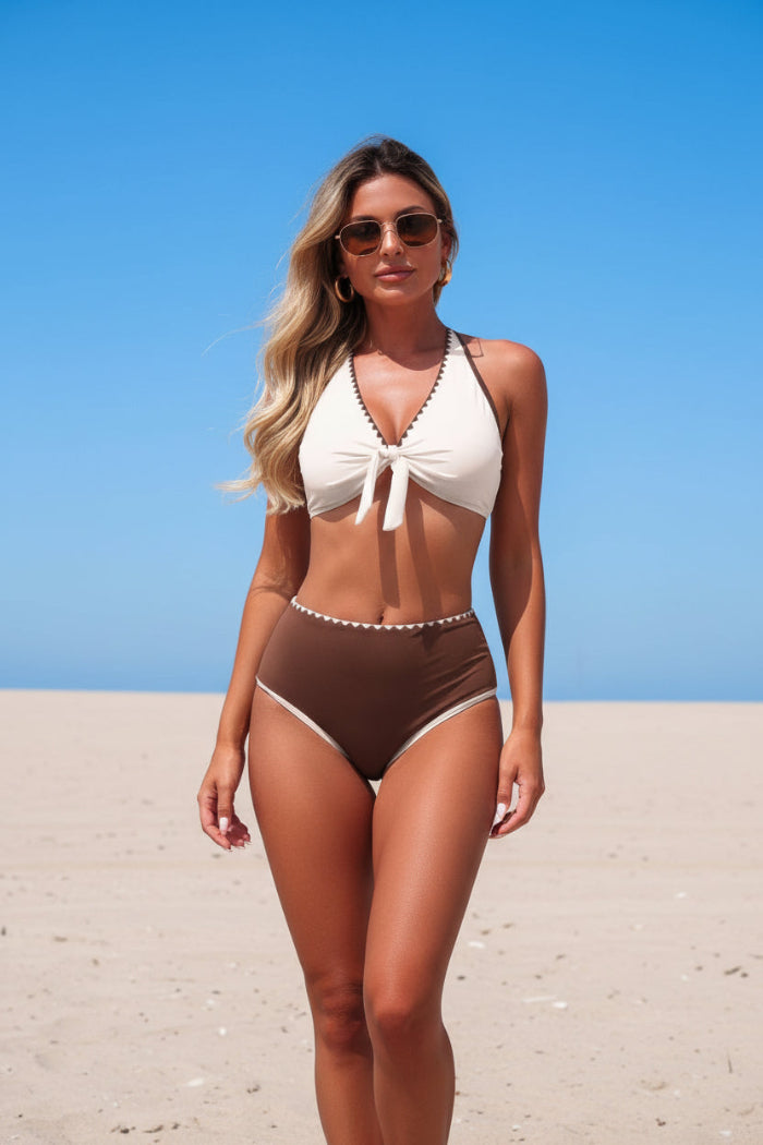 Woman in a white and brown bikini against a clear blue sky