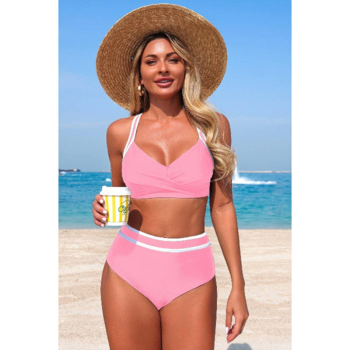 Woman in a pink bikini holding a coffee cup on a beach
