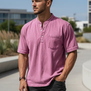 Man wearing a pink short-sleeve shirt with a pocket on a white background
