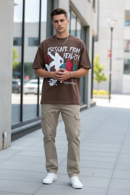 Person wearing a brown t-shirt with graphic design and text.