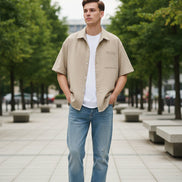 Beige shirt over a white t-shirt on a white background