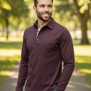 Man wearing a maroon long-sleeve shirt with a white collar on a white background