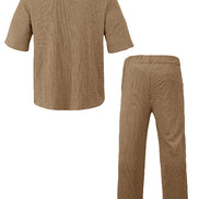 A two-piece black ribbed lounge set consisting of a short-sleeve button-up shirt and matching straight-leg pants, 
