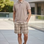 Beige polo shirt and plaid shorts set on a white background