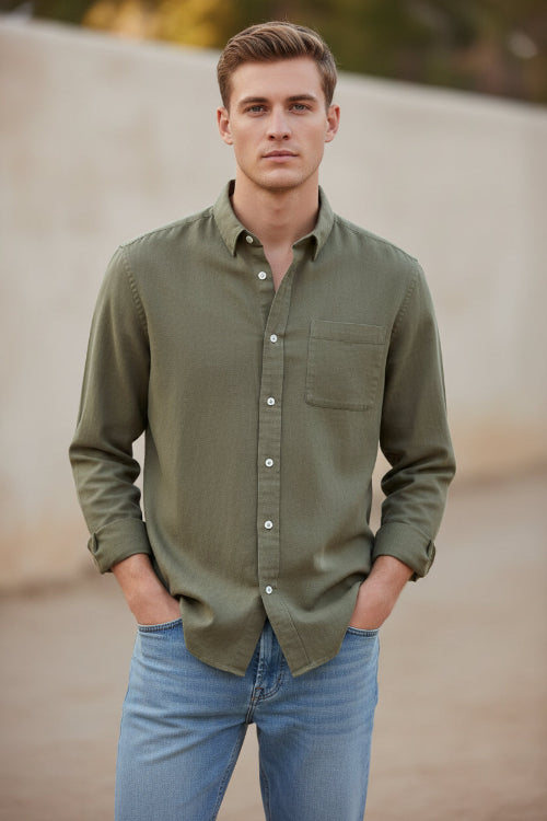 Beige button-up shirt worn by a person on a white background