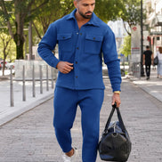 A man wearing a matching royal blue fleece jacket and jogger pants set, 