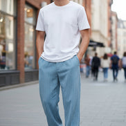 Blue corduroy pants worn by a person on a white background