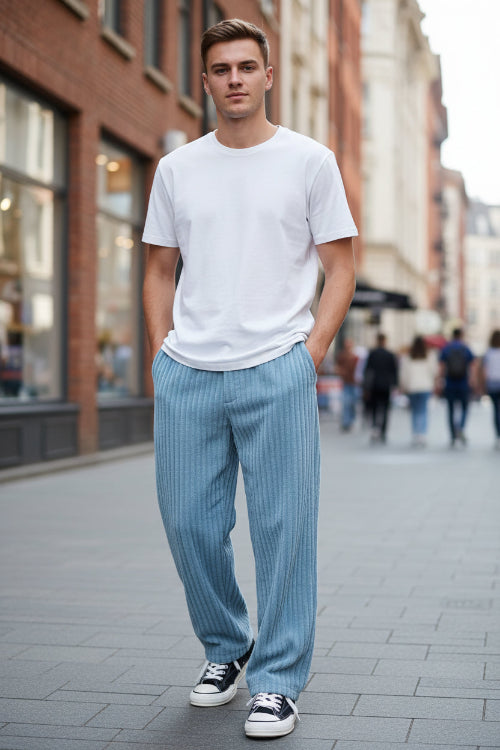 Blue corduroy pants worn by a person on a white background