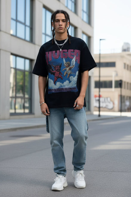 Person wearing a black t-shirt with a graphic design of a devil and angel on a blue background.