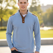 Light blue shirt with brown leather accents on a white background