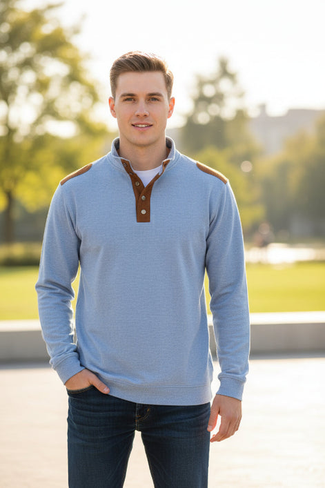 Light blue shirt with brown leather accents on a white background