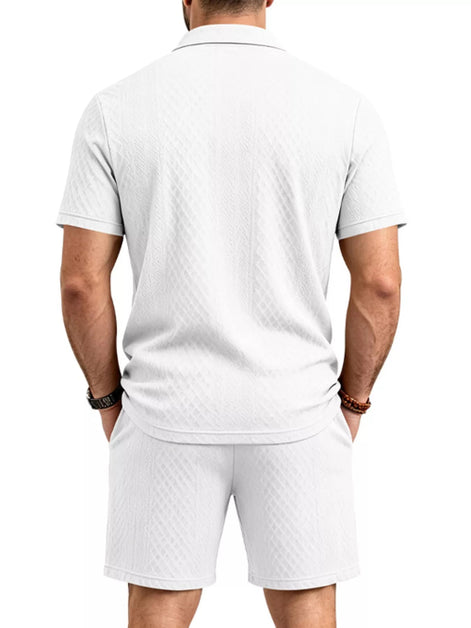 A man viewed from the back wearing a white short-sleeve polo shirt and matching white 