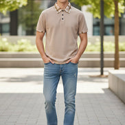 Beige polo shirt with plaid collar on a white background