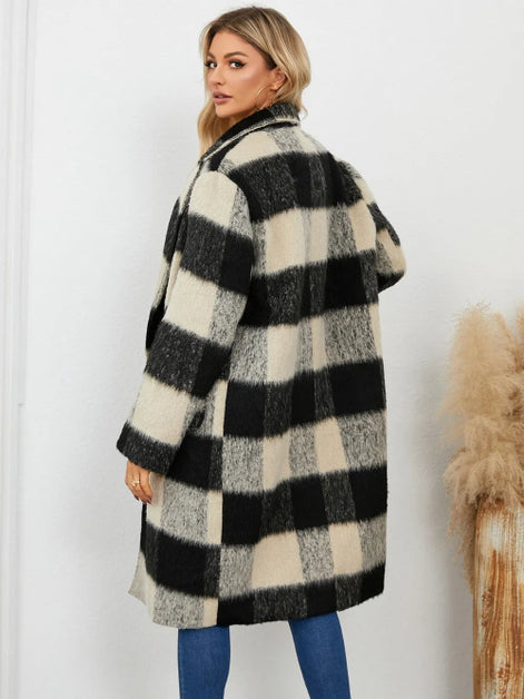 Woman wearing a black and white checkered coat against a white background