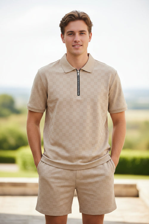 Man wearing a beige short-sleeve shirt and shorts set on a white background