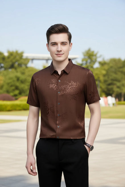 Brown floral patterned shirt worn by a person on a gray background