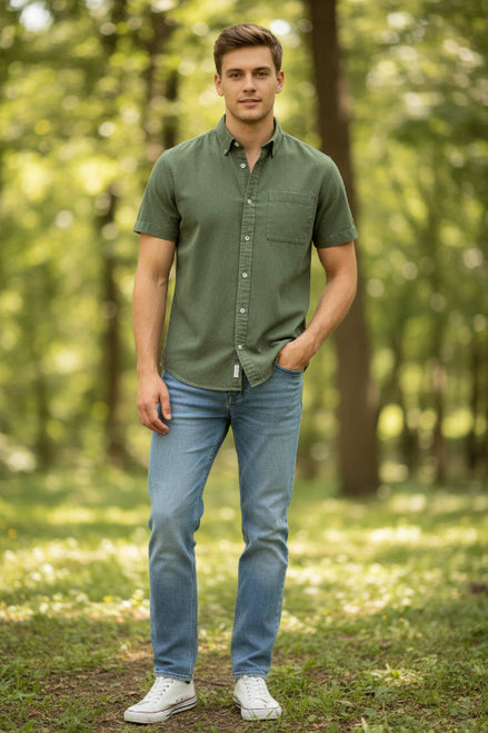 Green short-sleeve shirt worn by a person on a white background