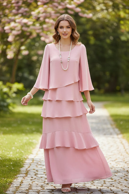Pink dress with layered skirt and three-quarter sleeves on a white background