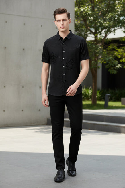 Black embroidered short-sleeve shirt on a gray background