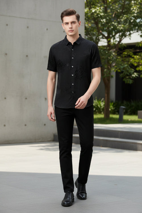 Black embroidered short-sleeve shirt on a gray background