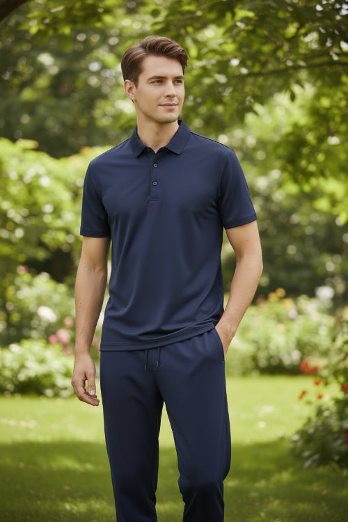 Navy blue polo shirt and pants set on a light gray surface with a blue gradient background.