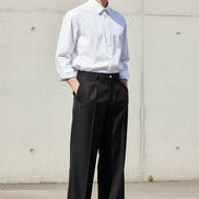 Black wide-leg pants on a white background