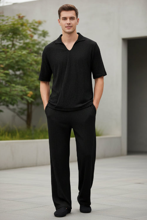 Black polo shirt and black pants on a white background