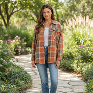 Woman wearing a plaid shirt outdoors with a blurred background