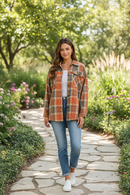 Woman wearing a plaid shirt outdoors with a blurred background