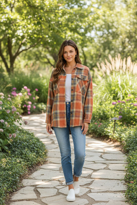 Woman wearing a plaid shirt outdoors with a blurred background