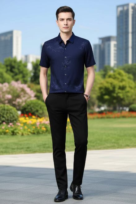 Navy blue embroidered shirt worn by a person on a gray background