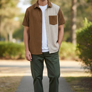 Brown and beige checkered shirt on a hanger against a white background
