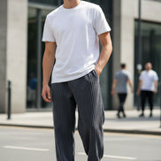 Gray corduroy pants worn by a person on a white background