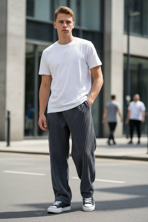 Gray corduroy pants worn by a person on a white background