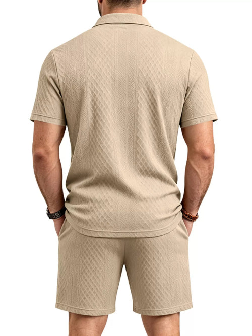 A man viewed from the back wearing a beige short-sleeve polo shirt and matching shorts, 