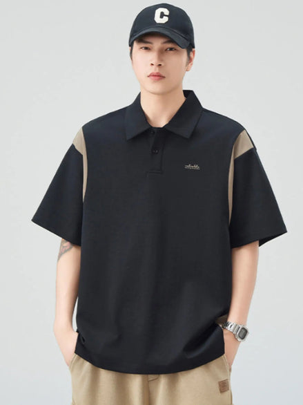 Person wearing a black and beige polo shirt with a cap on a light gray background