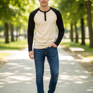Beige and black long-sleeve shirt with button details on a white background