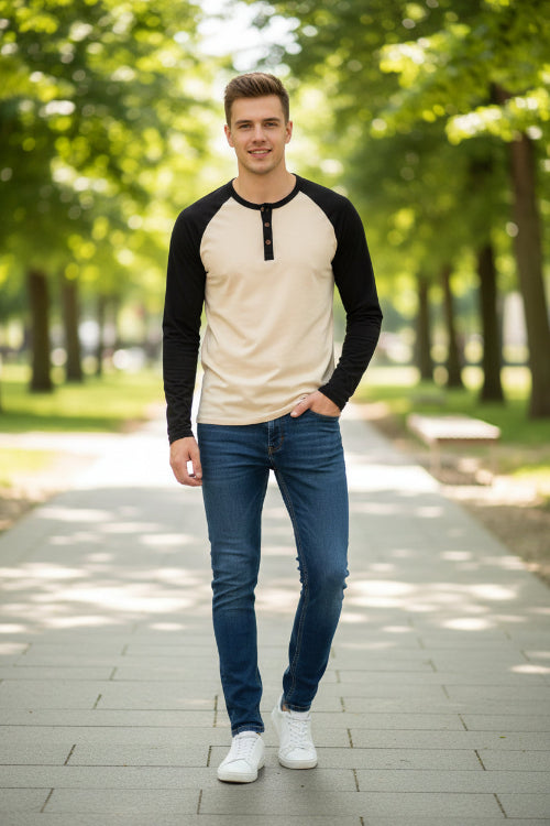 Beige and black long-sleeve shirt with button details on a white background