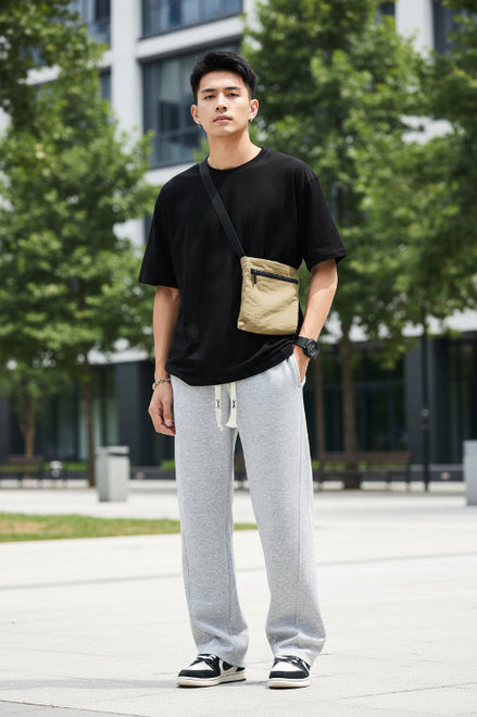 Person wearing gray sweatpants on a white background