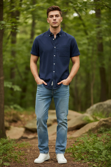 Navy blue button-up shirt worn by a person on a light gray background