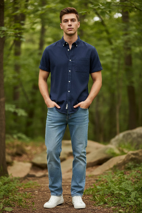 Navy blue button-up shirt worn by a person on a light gray background