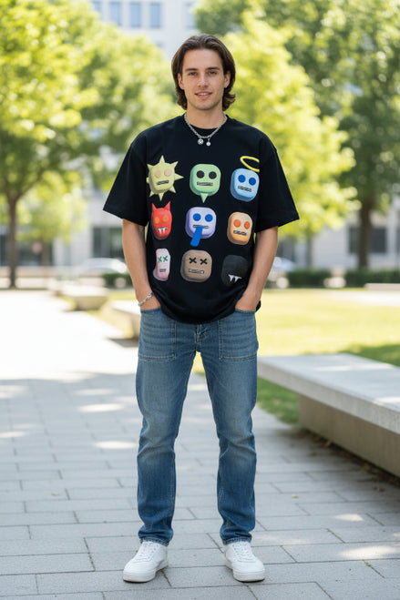 Person wearing a black t-shirt with colorful emoji designs on a white background
