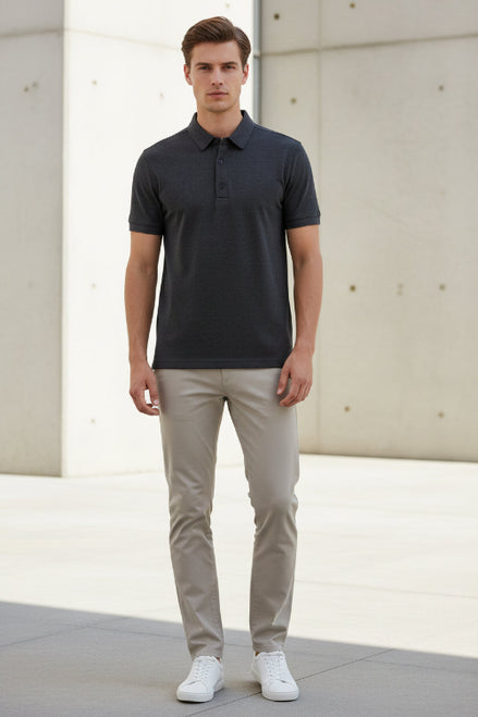 Folded dark gray shirt on a gray surface