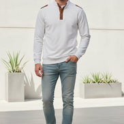 White shirt with brown leather accents on a gray background