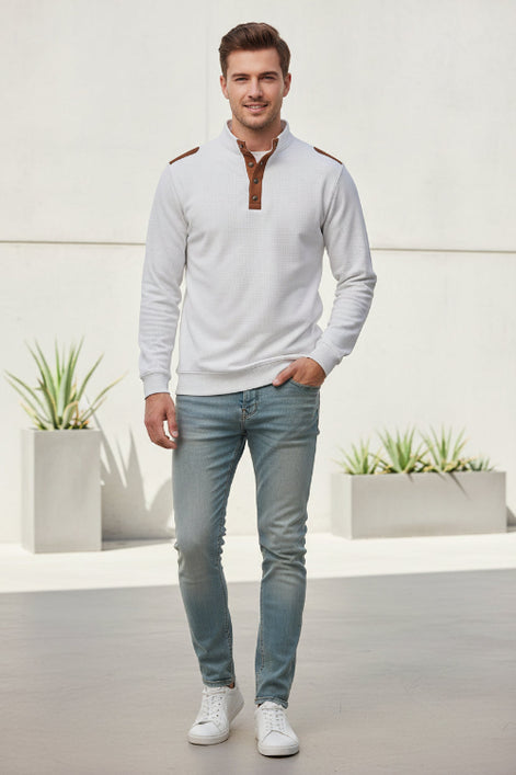 White shirt with brown leather accents on a gray background