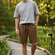 Brown checkered shorts with drawstring on a white background
